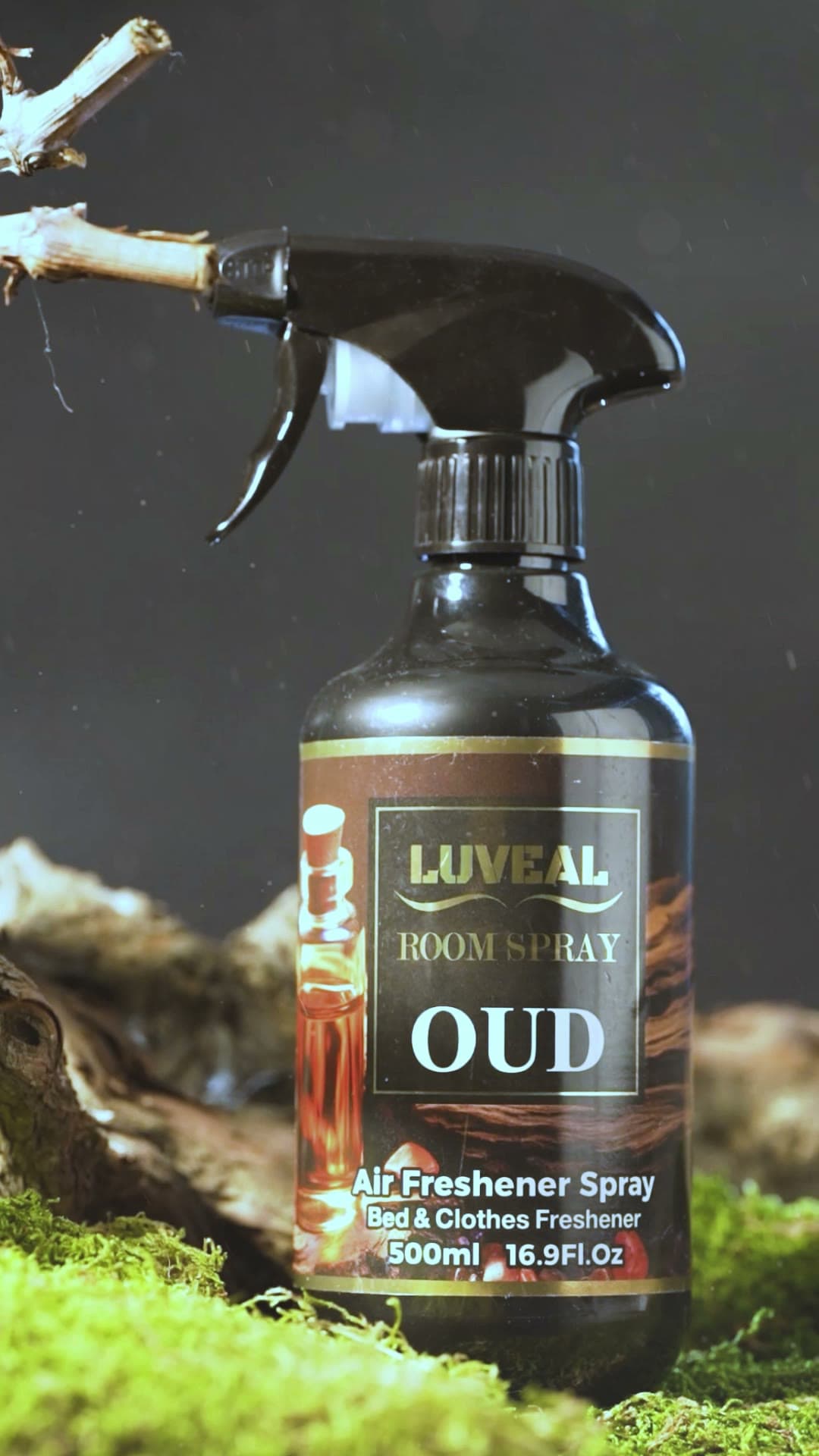 A Luveal OUD room spray bottle standing on wet moss
